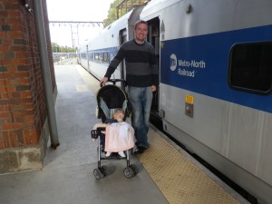I stand with my daughter, sleeping in her stroller, and the Metro-North train that took us to the end of the Hudson Line in Poughkeepsie, New York, on 22 October 2011. My daughter had just turned 1 a few months earlier.